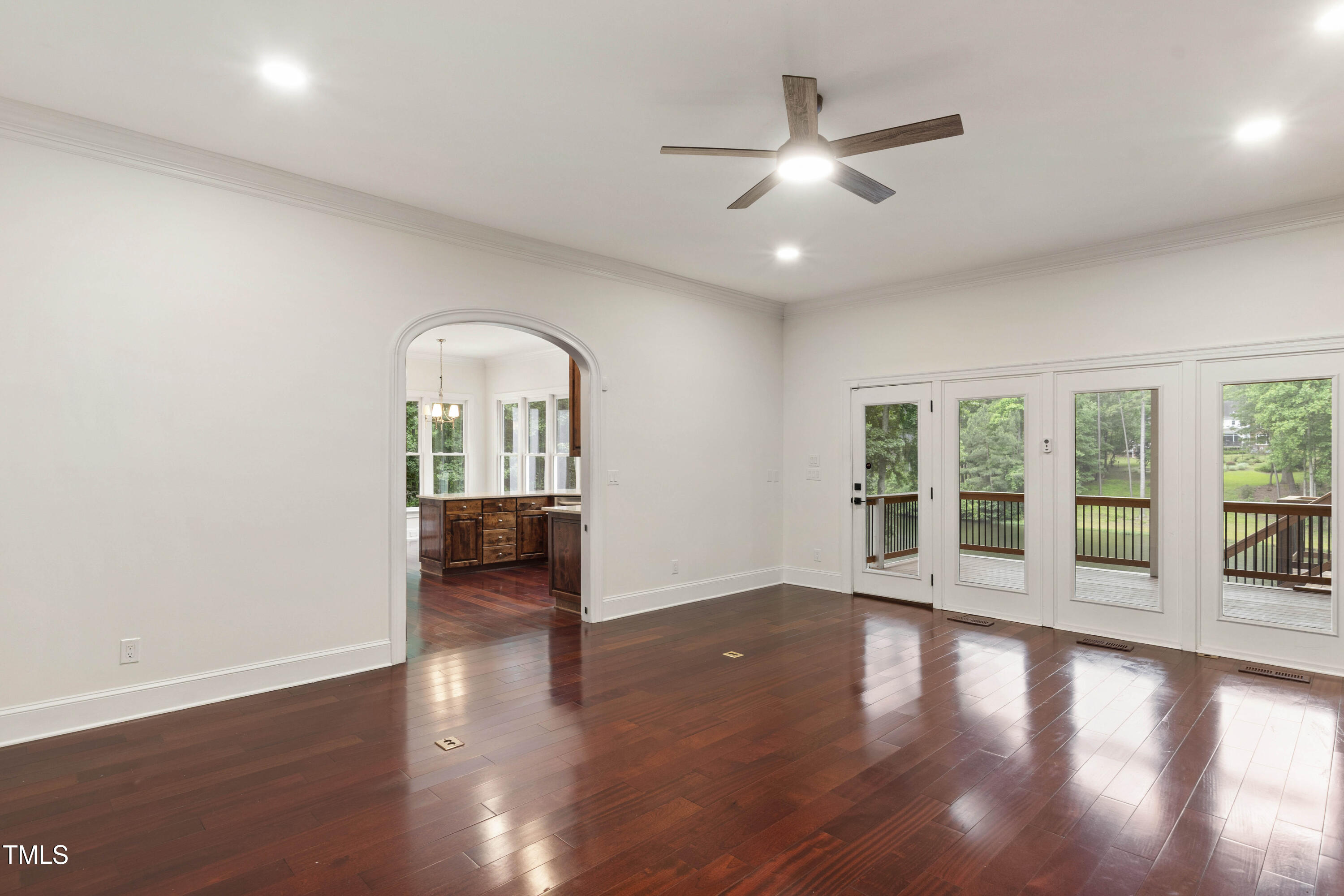 636 Pendleton Lake Road Raleigh, NC 27614 - Photo 20 of 88 a view of a livingroom with wooden floor a ceiling fan and windows