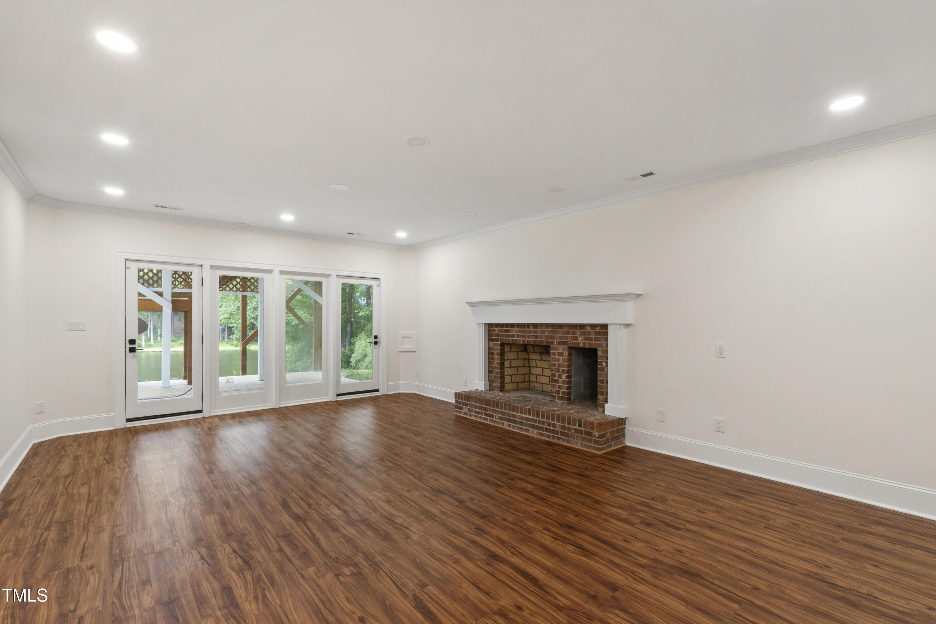 636 Pendleton Lake Road Raleigh, NC 27614 - Photo 23 of 88 a view of empty room with wooden floor and fireplace