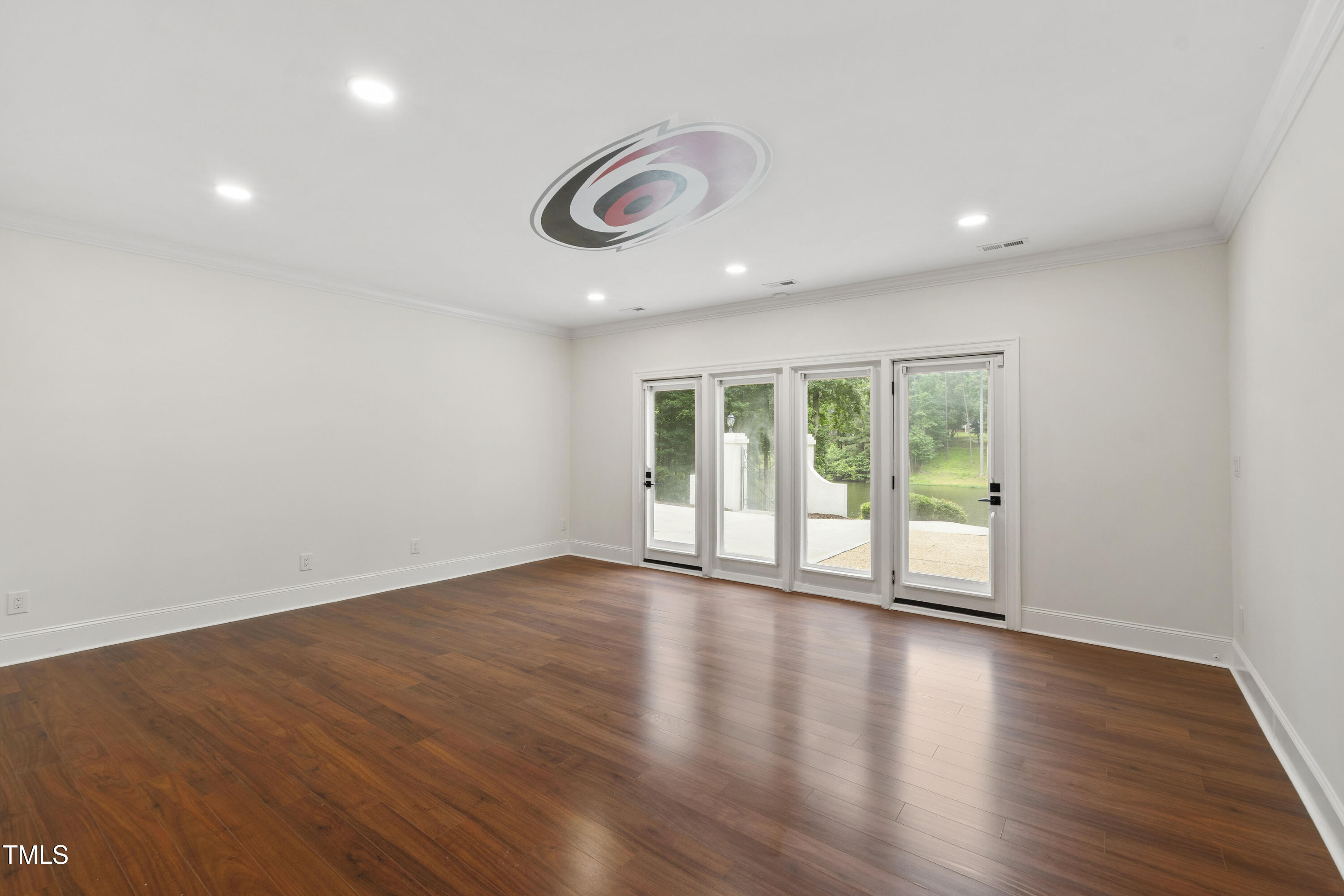 636 Pendleton Lake Road Raleigh, NC 27614 - Photo 26 of 88 a view of an empty room with wooden floor and a window