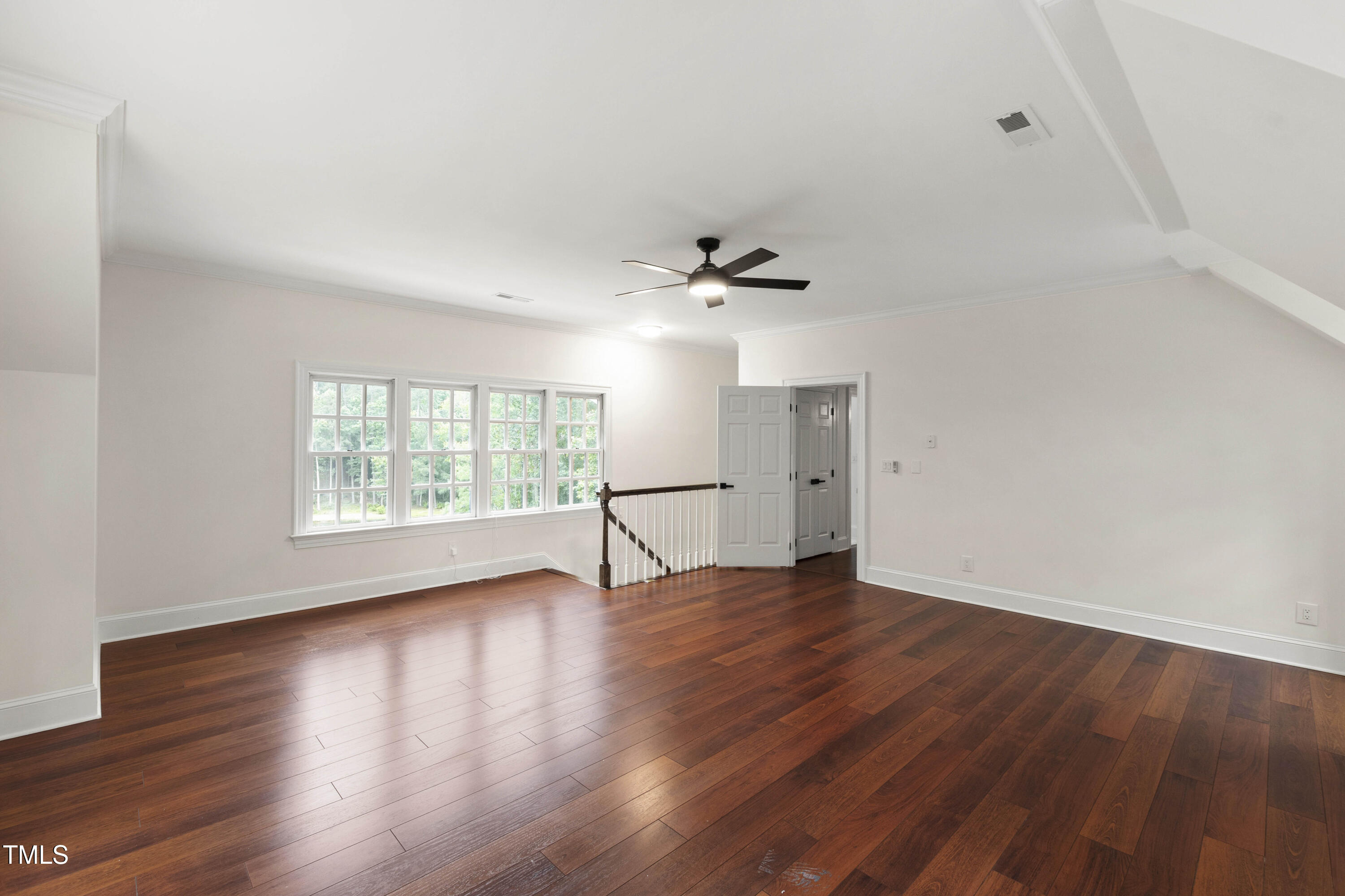636 Pendleton Lake Road Raleigh, NC 27614 - Photo 32 of 88 a view of an empty room with wooden floor and a window