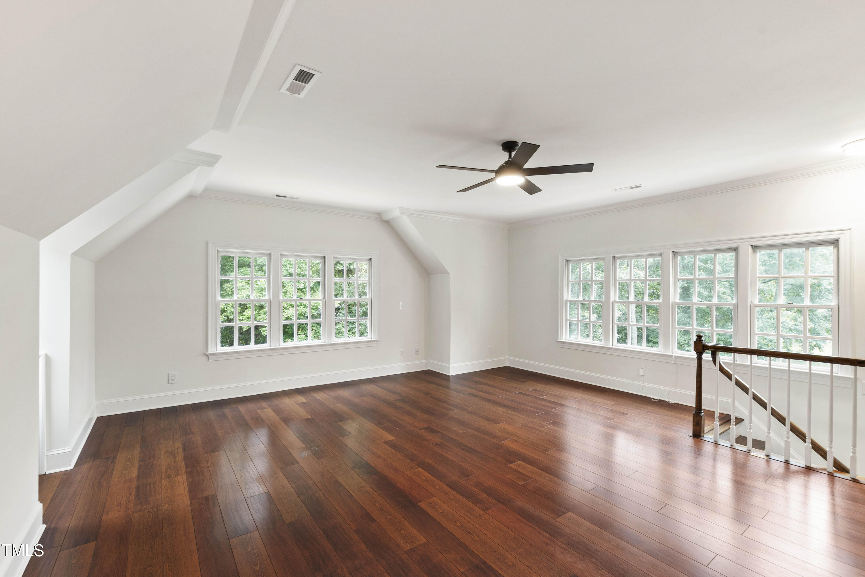 636 Pendleton Lake Road Raleigh, NC 27614 - Photo 33 of 88 an empty room with wooden floor fan and windows
