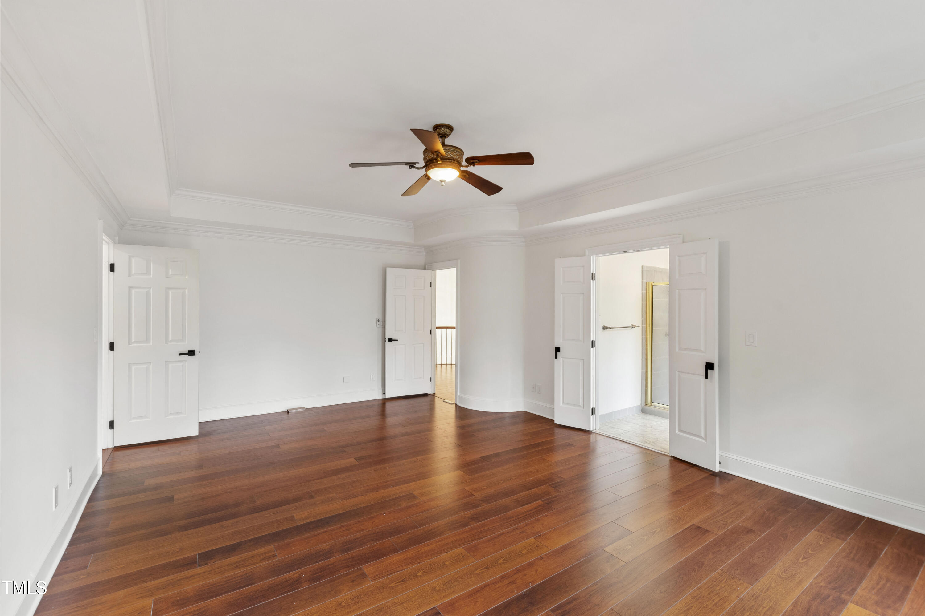 636 Pendleton Lake Road Raleigh, NC 27614 - Photo 36 of 88 a view of a room with wooden floor and a ceiling fan