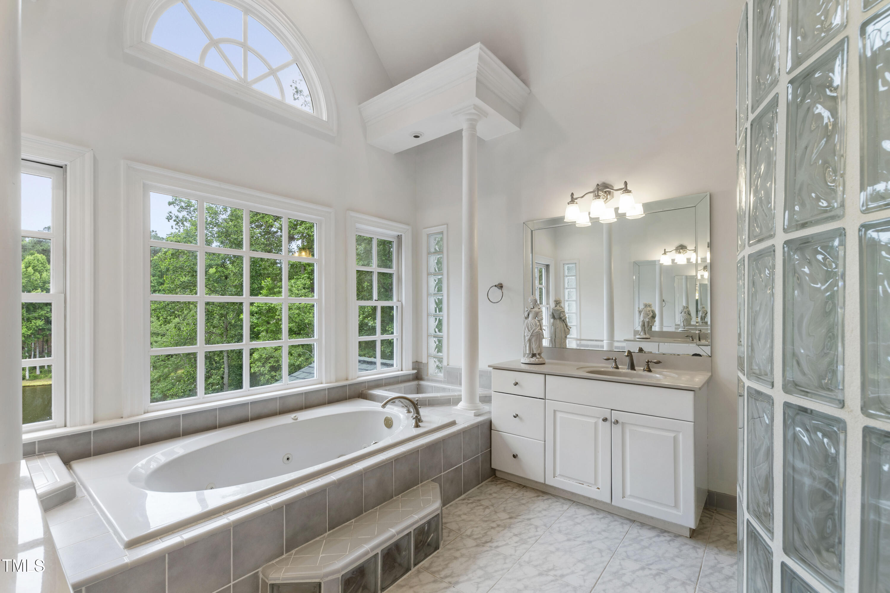 636 Pendleton Lake Road Raleigh, NC 27614 - Photo 40 of 88 a bathroom with a granite countertop tub a sink and a large window