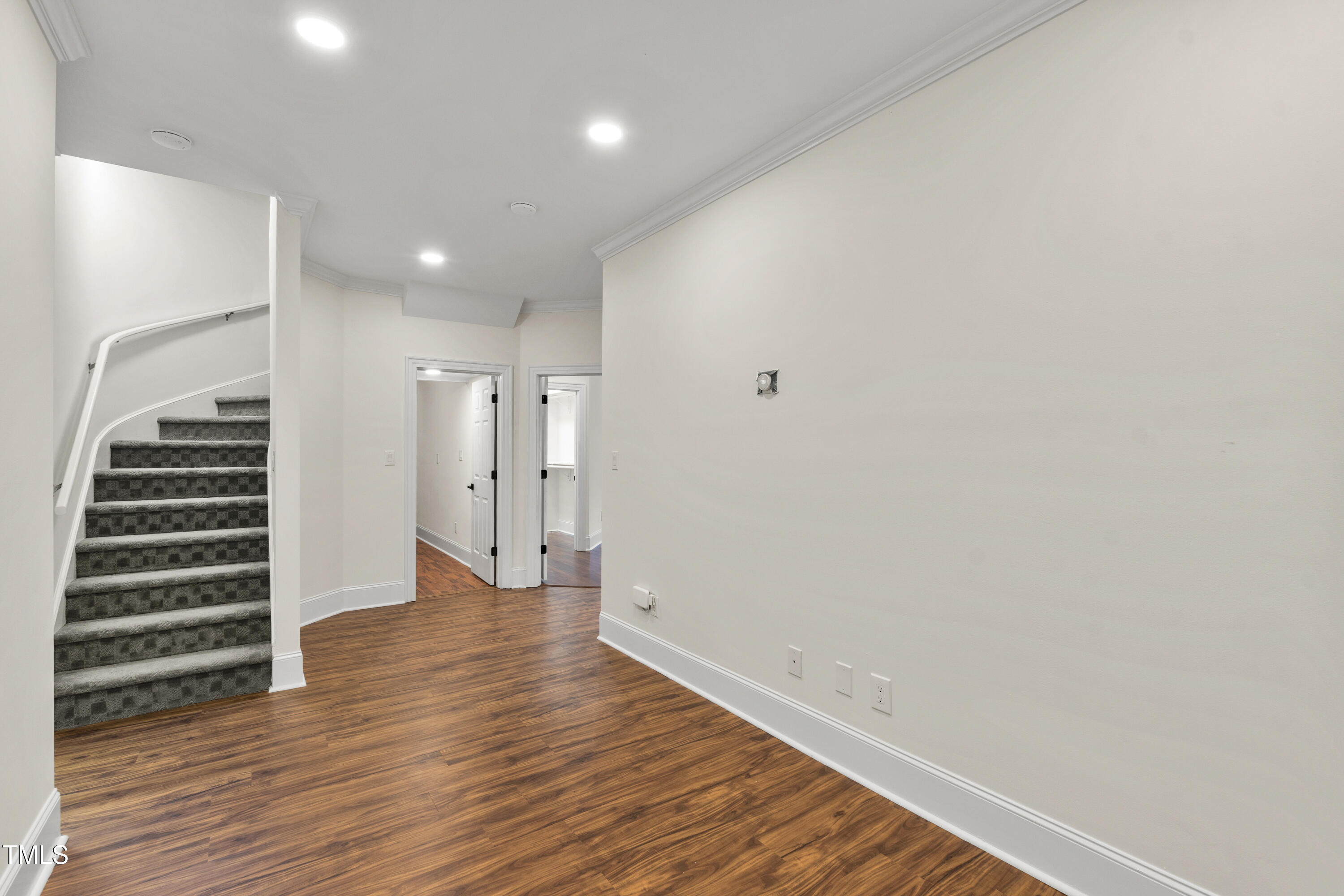 636 Pendleton Lake Road Raleigh, NC 27614 - Photo 44 of 88 a view of an empty room with wooden floor and stairs