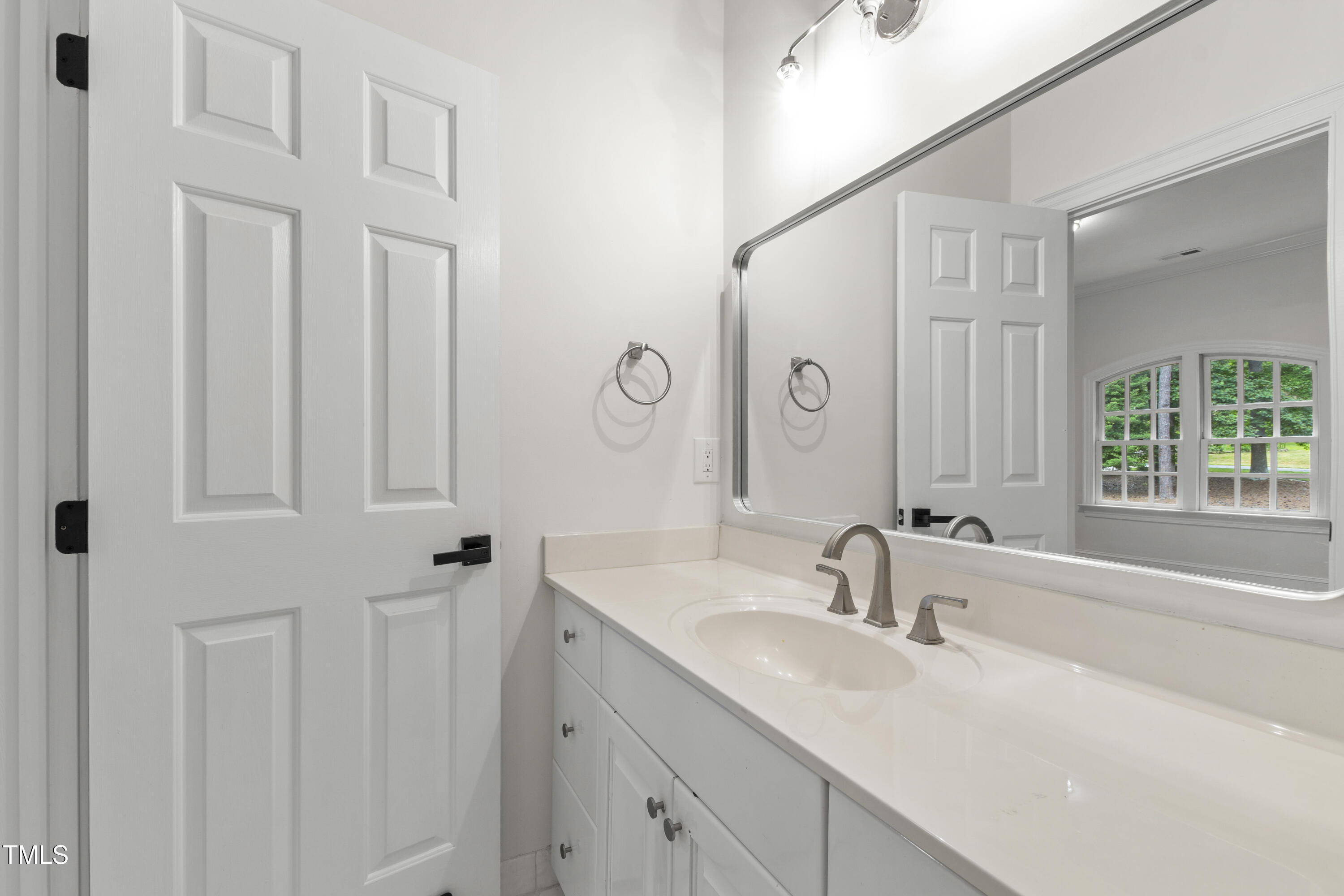 636 Pendleton Lake Road Raleigh, NC 27614 - Photo 60 of 88 a bathroom with double vanity sink a mirror and a bathtub