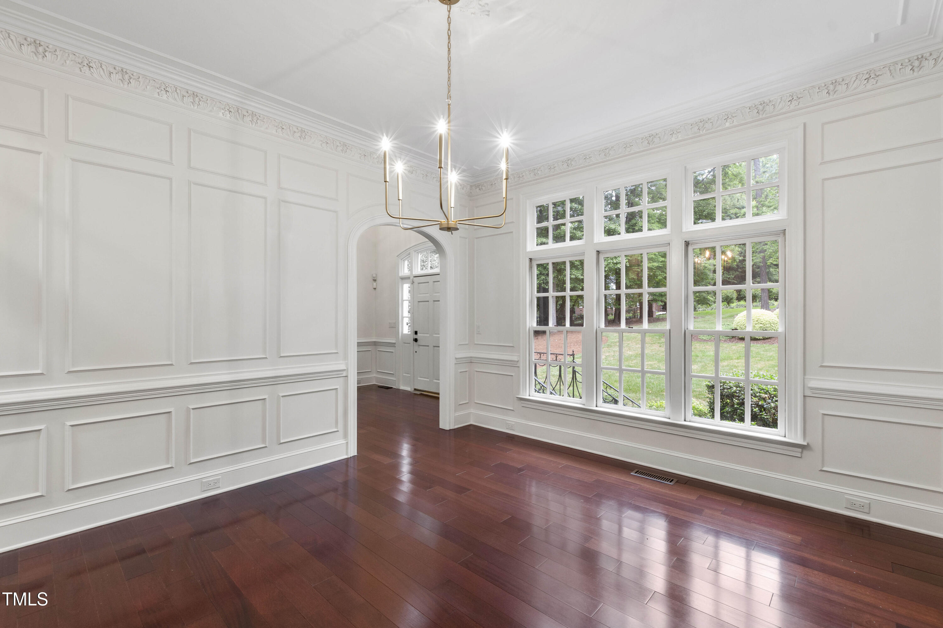 636 Pendleton Lake Road Raleigh, NC 27614 - Photo 4 of 88 a view of an empty room with a window and wooden floor