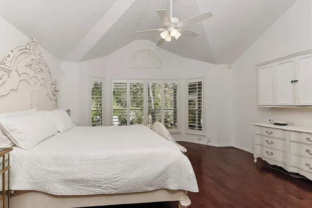 a bathroom with a granite countertop sink a toilet and shower