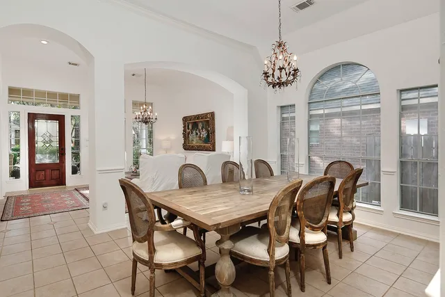 a view of a dining room with furniture wooden floor and chandelier
