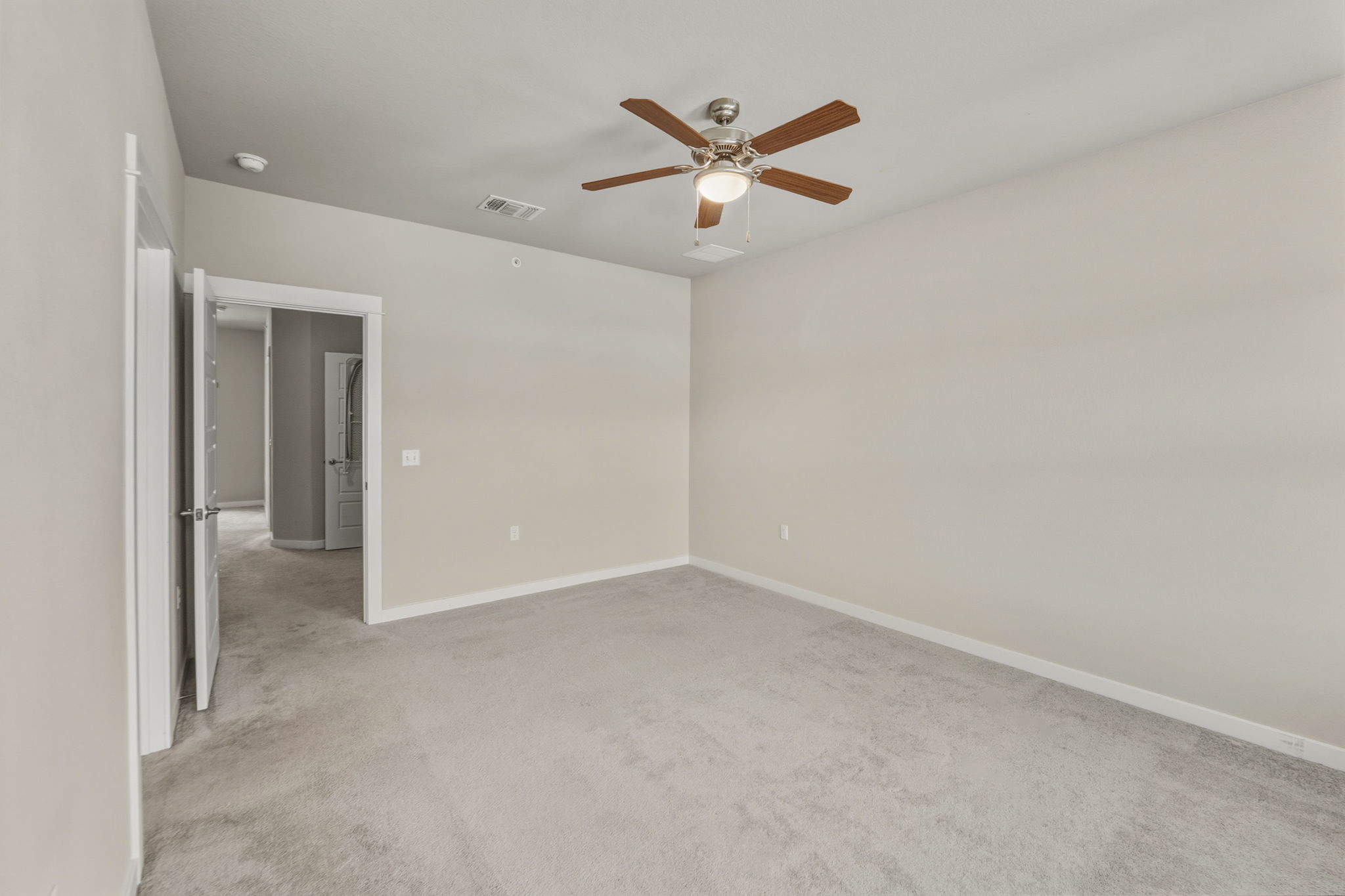 3919 Vaughan Street Austin, TX 78723 - Photo 24 of 40 An inviting atmosphere awaits in this carpeted room, featuring a modern ceiling fan for comfort.