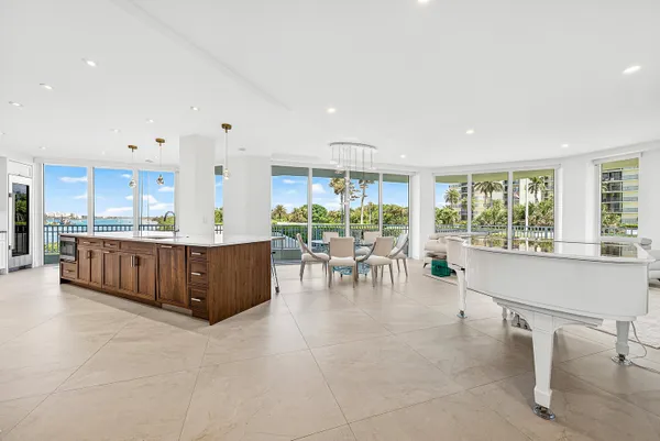 a kitchen with stainless steel appliances kitchen island granite countertop a stove a sink and a refrigerator