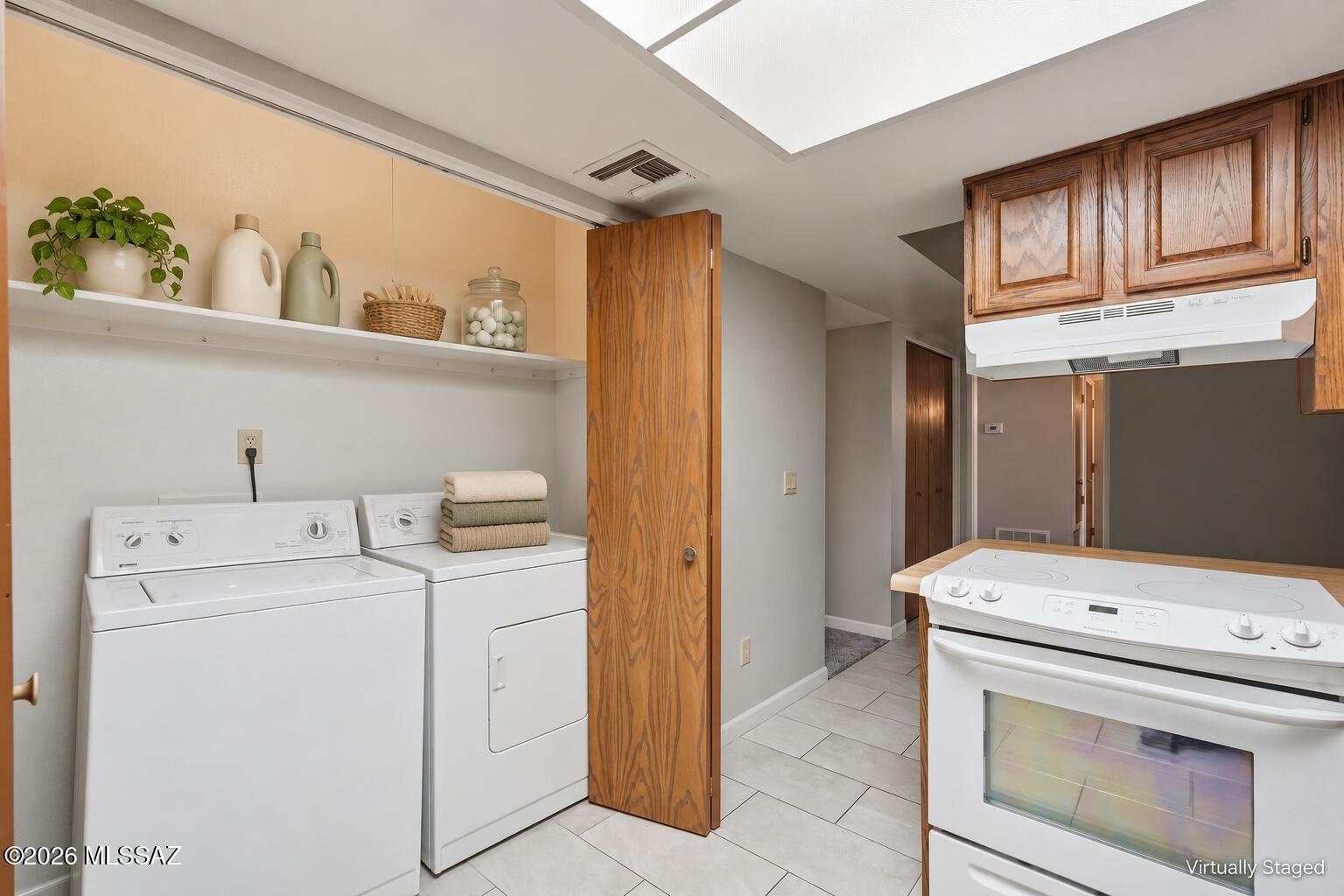 1949 North Swan Road, Unit 31 Tucson, AZ 85712 - Photo 10 of 33 Large capacity washer and dryer behind the bi-fold doors are included with your new condo!