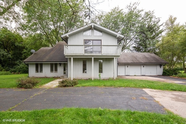 3017 Springbrook Road Crystal Lake, IL 60012 - Photo 1 of 20 a front view of a house with a yard and garage