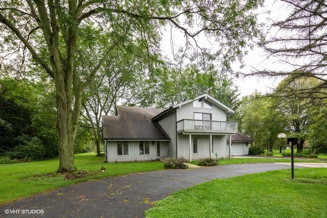 3017 Springbrook Road Crystal Lake, IL 60012 - Photo 2 of 20 a front view of a house with a yard and trees
