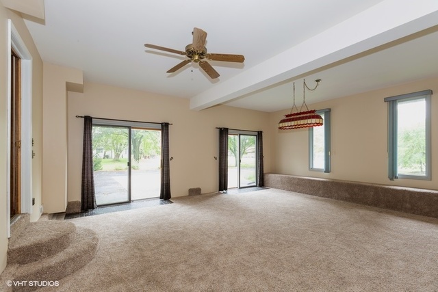 3017 Springbrook Road Crystal Lake, IL 60012 - Photo 17 of 20 a view of a livingroom with a ceiling fan and window