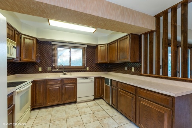 3017 Springbrook Road Crystal Lake, IL 60012 - Photo 4 of 20 a kitchen with a sink cabinets and window