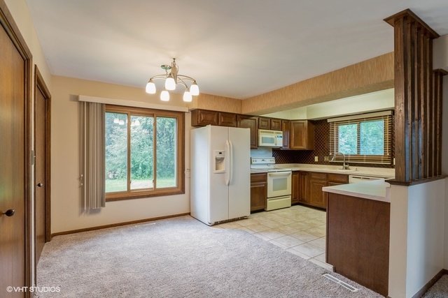 3017 Springbrook Road Crystal Lake, IL 60012 - Photo 5 of 20 a view of a kitchen with a sink stove and a window