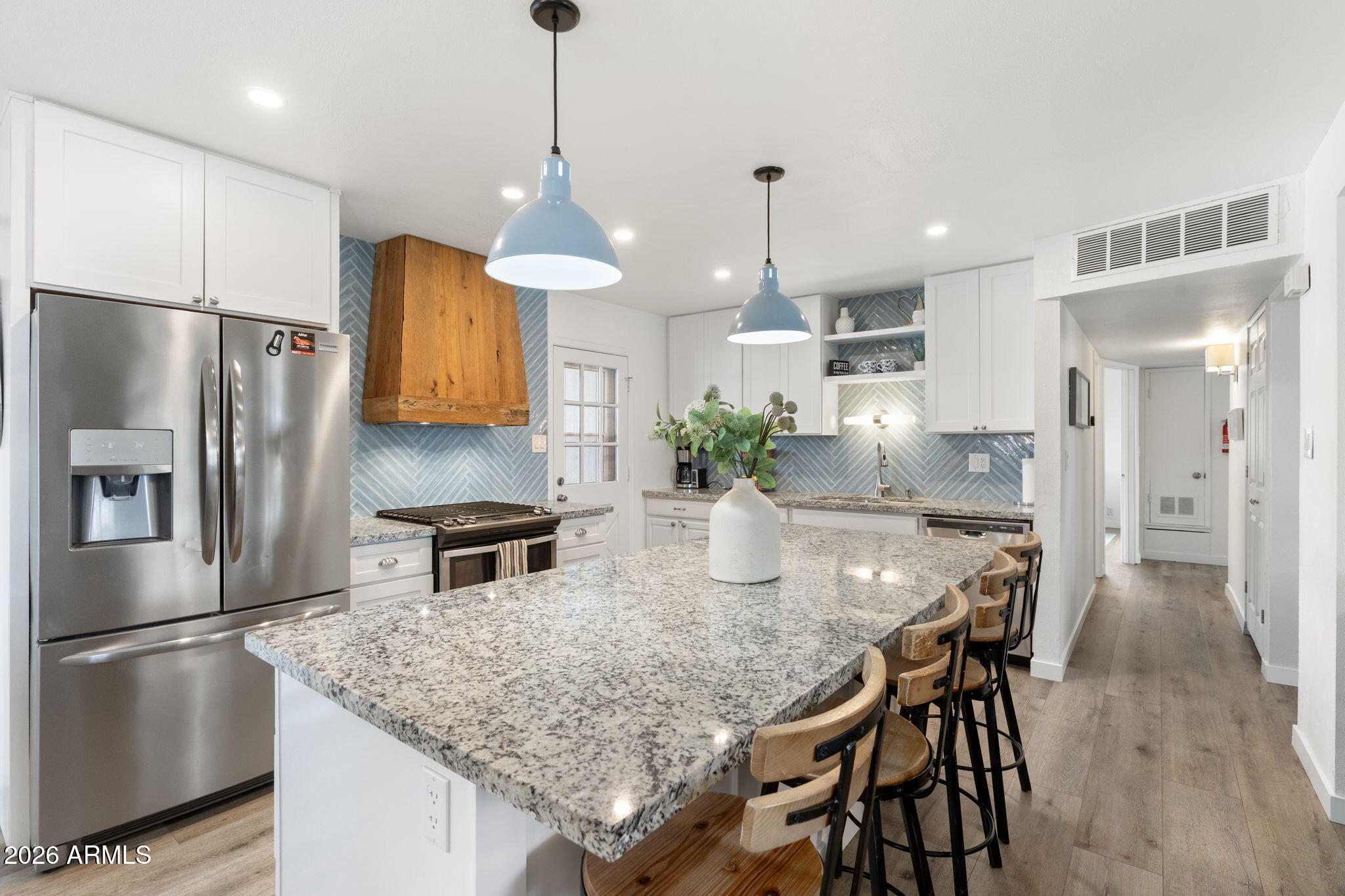 133 East Pierce Street Tempe, AZ 85288 - Photo 12 of 37 a kitchen with stainless steel appliances granite countertop a kitchen island and a refrigerator