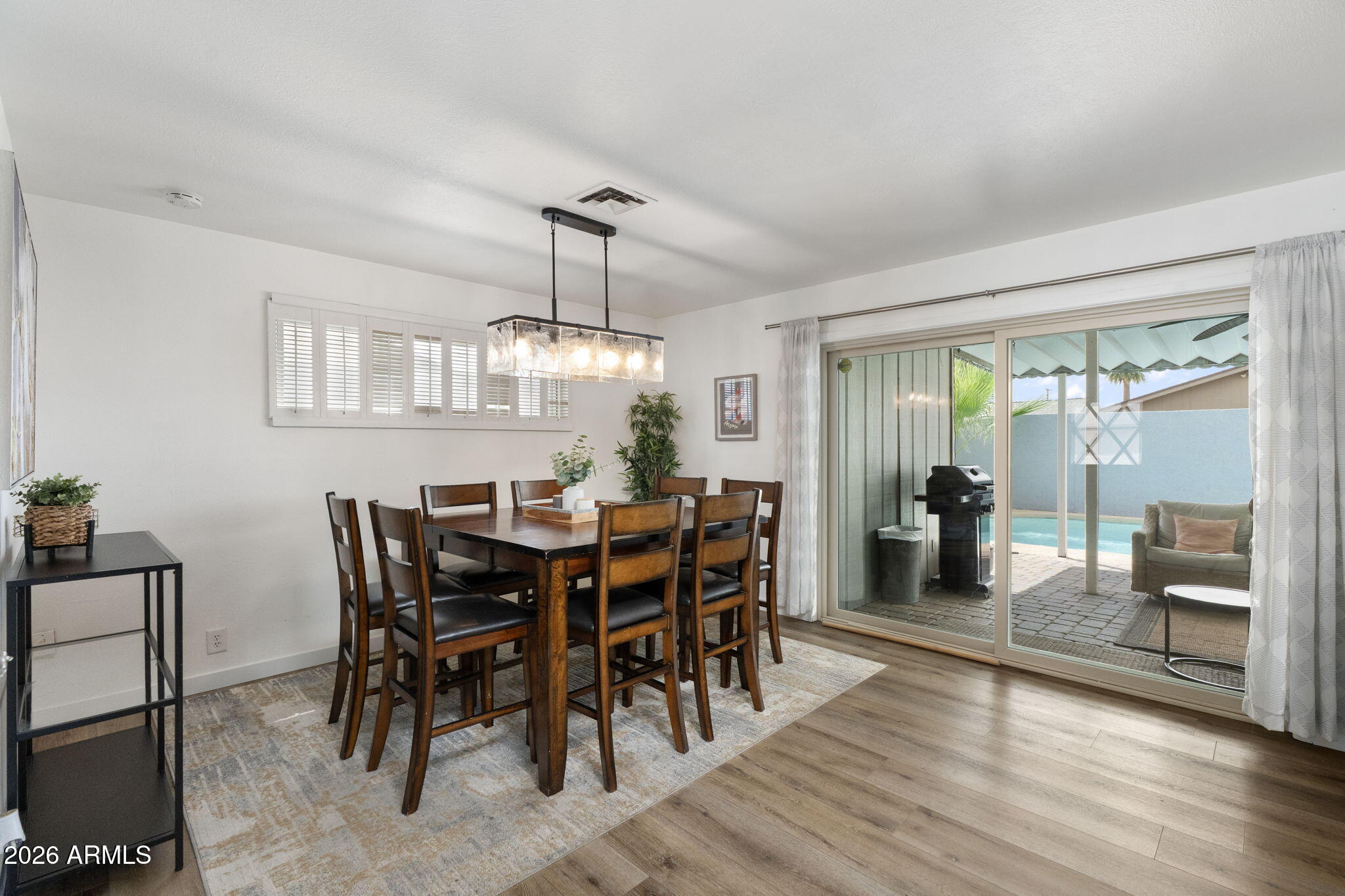 133 East Pierce Street Tempe, AZ 85288 - Photo 18 of 37 a view of a dining room and livingroom with furniture wooden floor a chandelier