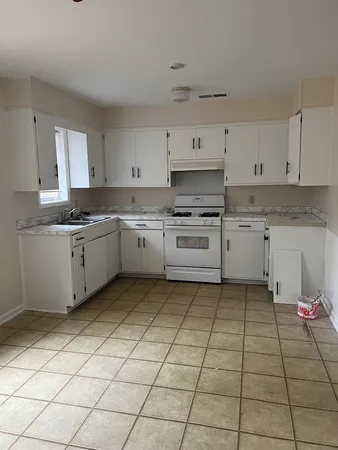 a kitchen with a stove a sink and a refrigerator