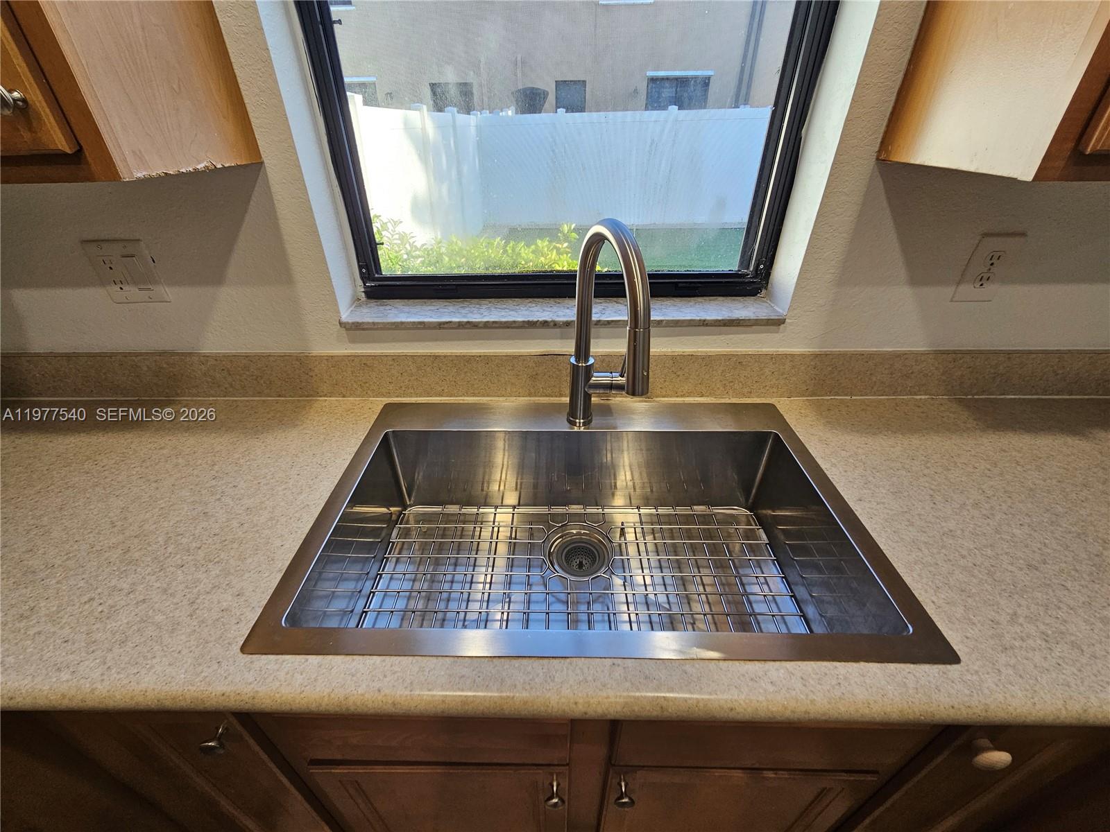 3370 West 90th Street, Unit A Hialeah, FL 33018 - Photo 15 of 40 a kitchen with kitchen island a sink granite counter tops and a stove