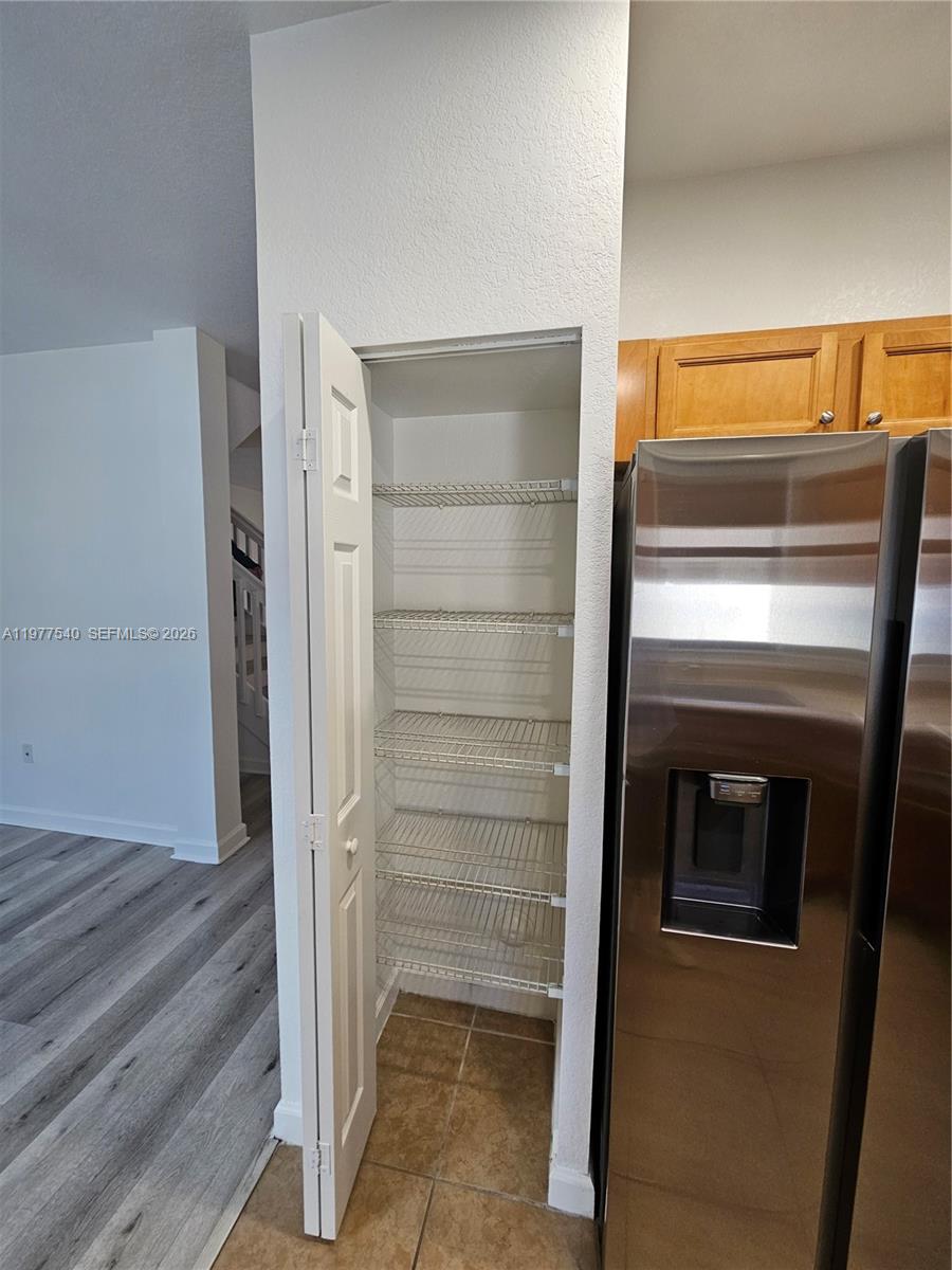 3370 West 90th Street, Unit A Hialeah, FL 33018 - Photo 16 of 40 a view of walk in closet with wooden floor