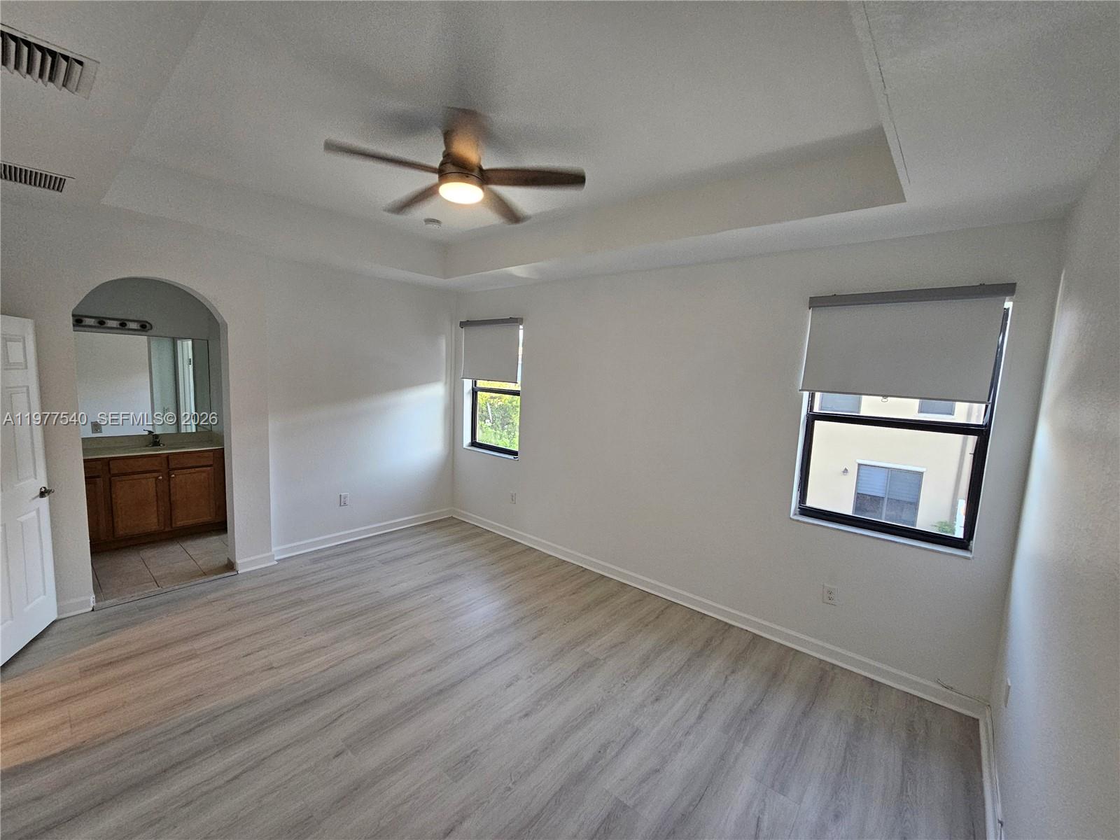 3370 West 90th Street, Unit A Hialeah, FL 33018 - Photo 20 of 40 wooden floor in an empty room with a window