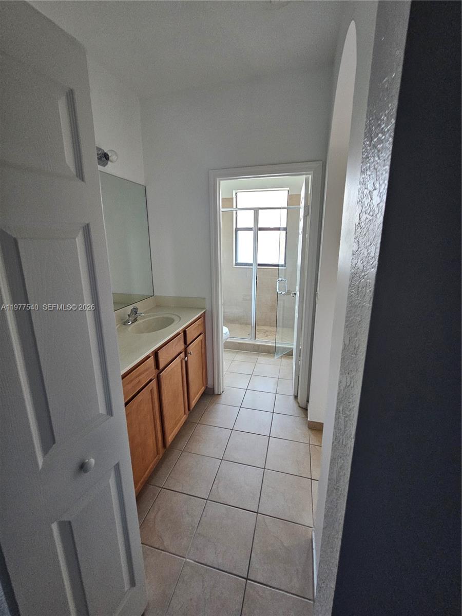 3370 West 90th Street, Unit A Hialeah, FL 33018 - Photo 23 of 40 a bathroom with a sink a toilet and a shower