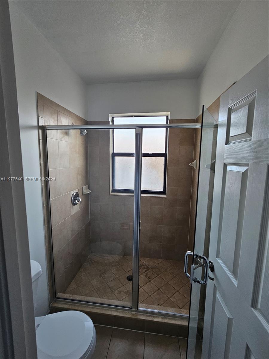 3370 West 90th Street, Unit A Hialeah, FL 33018 - Photo 24 of 40 a bathroom with a shower a toilet and a sink