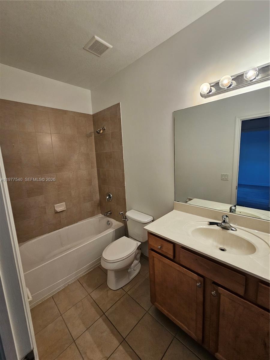 3370 West 90th Street, Unit A Hialeah, FL 33018 - Photo 29 of 40 a bathroom with a sink a toilet a mirror and bathtub