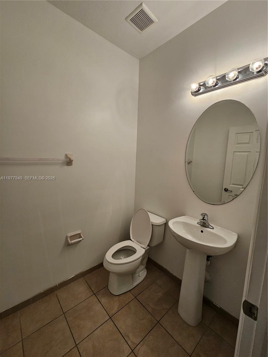 3370 West 90th Street, Unit A Hialeah, FL 33018 - Photo 33 of 40 a bathroom with a sink toilet and a mirror