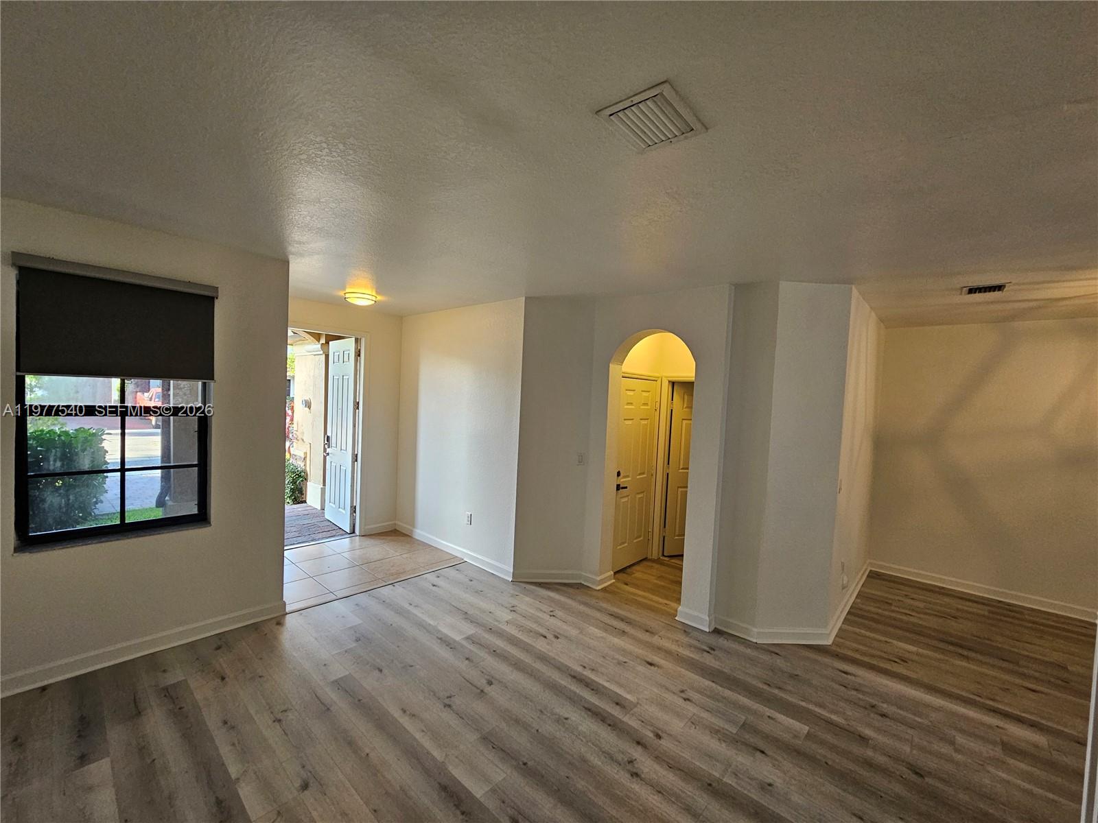 3370 West 90th Street, Unit A Hialeah, FL 33018 - Photo 5 of 40 a view of empty room with wooden floor and window