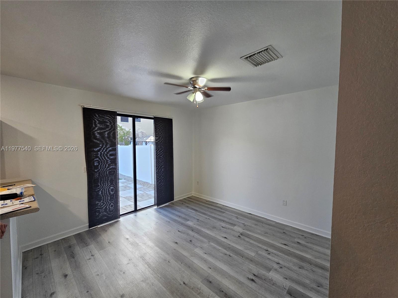 3370 West 90th Street, Unit A Hialeah, FL 33018 - Photo 8 of 40 wooden floor in an empty room with a window