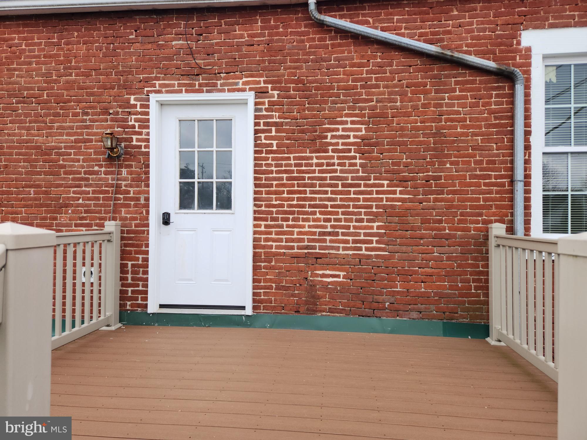 a view of front door of house with stairs