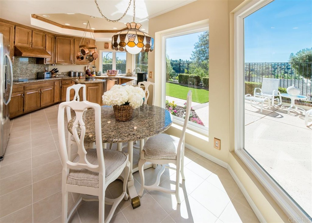 a view of a dining room with furniture a chandelier and wooden floor