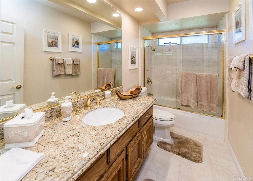 28741 Springfield Drive Laguna Niguel, CA 92677 - Photo 3 of 7 a bathroom with a granite countertop sink toilet a mirror and shower