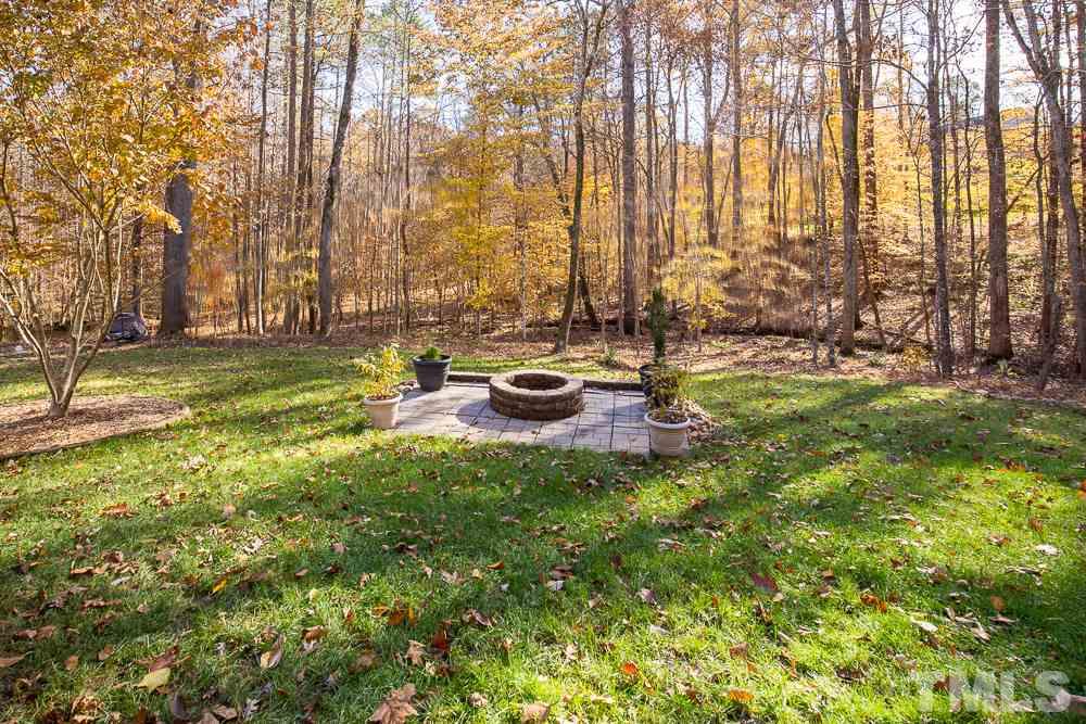 5001 Perception Lane Raleigh, NC 27613 - Photo 2 of 28 a backyard of a house with table and chairs