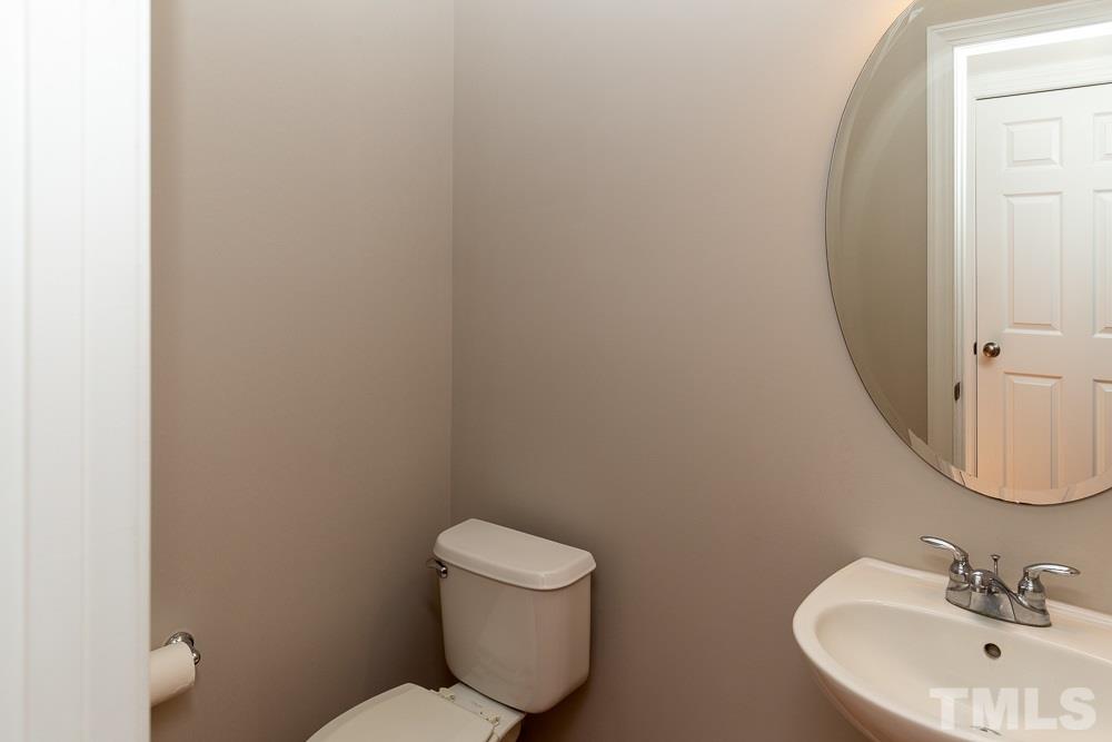 5001 Perception Lane Raleigh, NC 27613 - Photo 11 of 28 a bathroom with a toilet a sink and mirror