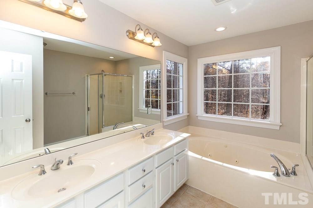 5001 Perception Lane Raleigh, NC 27613 - Photo 15 of 28 a bathroom with a large tub shower and sink