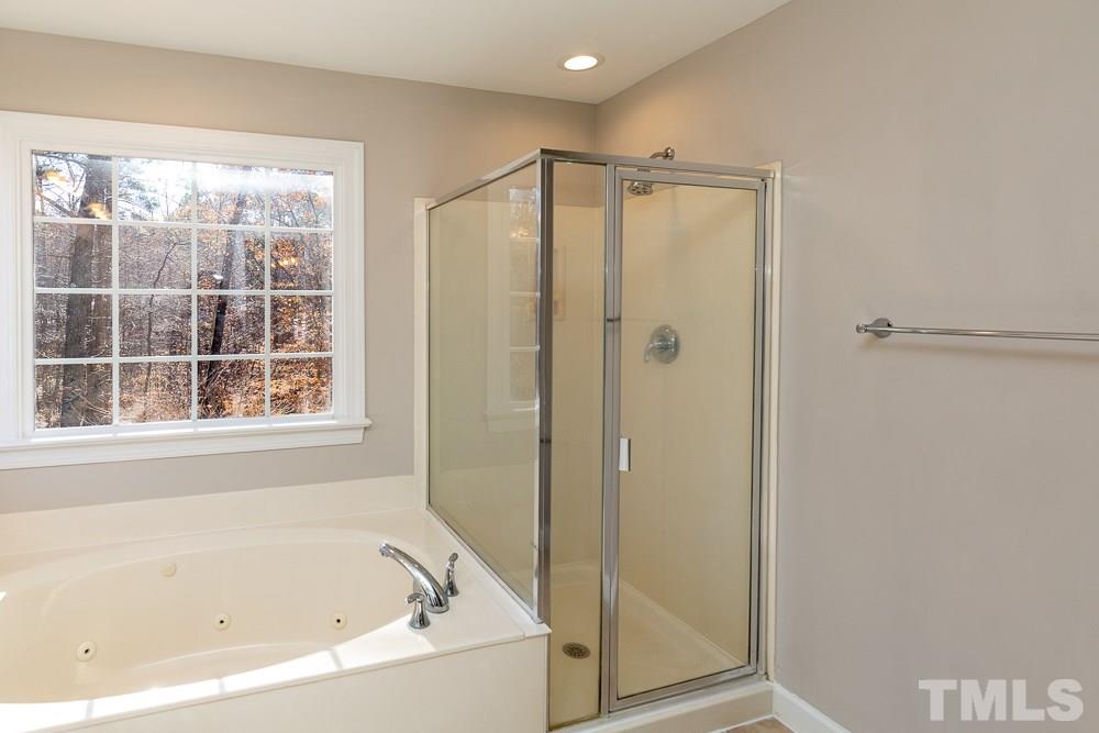 5001 Perception Lane Raleigh, NC 27613 - Photo 16 of 28 a bathroom with a bathtub and a shower