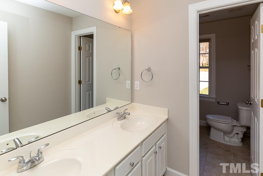 5001 Perception Lane Raleigh, NC 27613 - Photo 20 of 28 a bathroom with a sink and a mirror