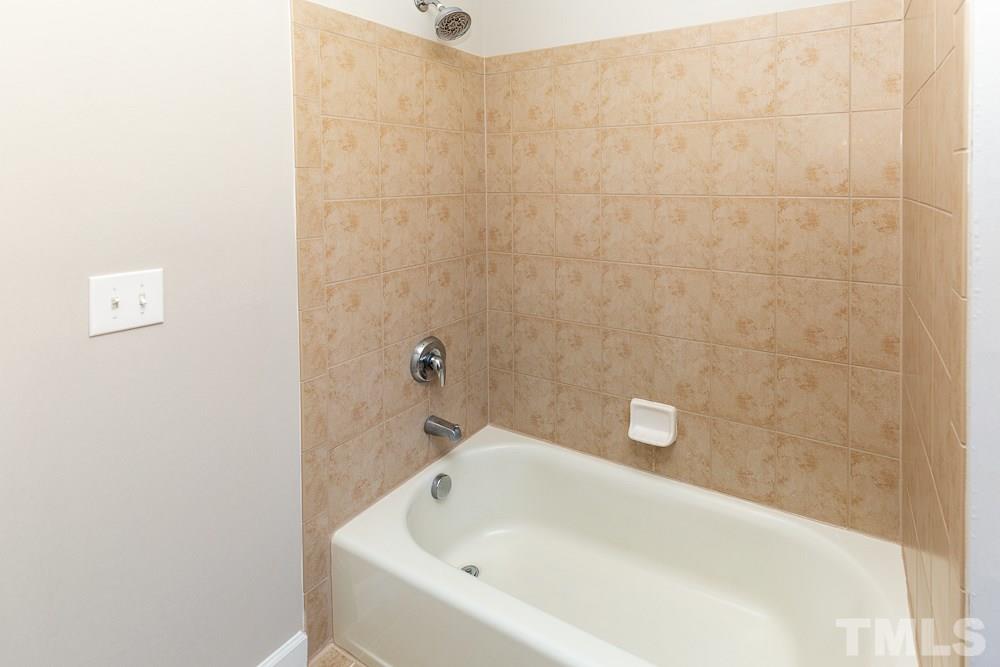 5001 Perception Lane Raleigh, NC 27613 - Photo 21 of 28 a bathroom with a white bath tub