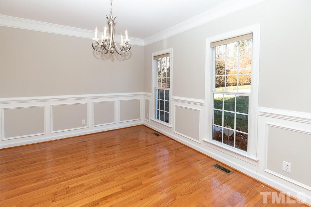 5001 Perception Lane Raleigh, NC 27613 - Photo 4 of 28 a view of an empty room with wooden floor and a window