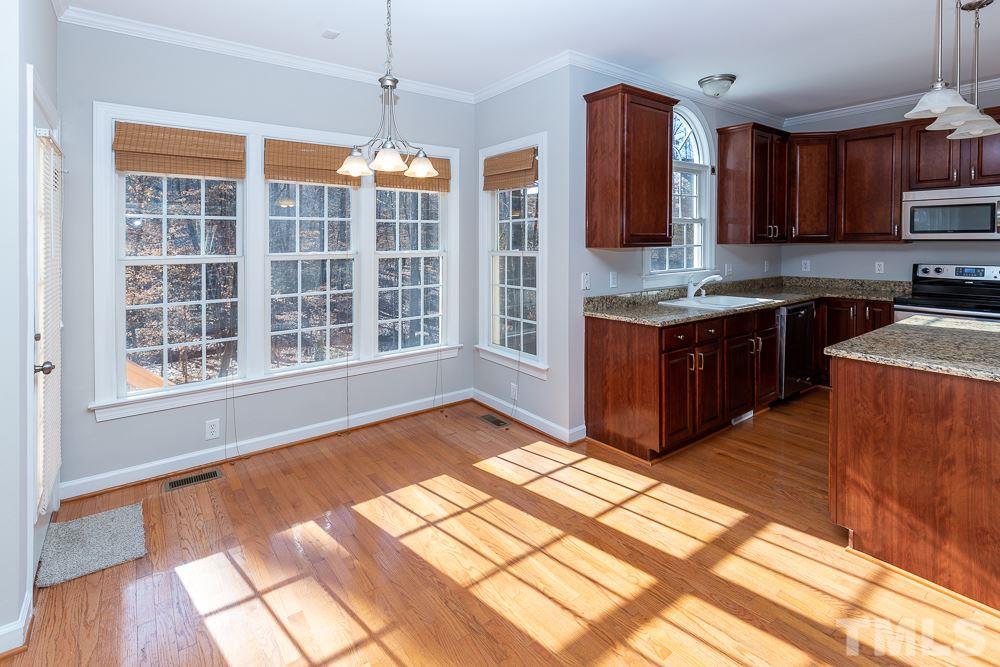 5001 Perception Lane Raleigh, NC 27613 - Photo 6 of 28 a kitchen with stainless steel appliances granite countertop a stove and a sink