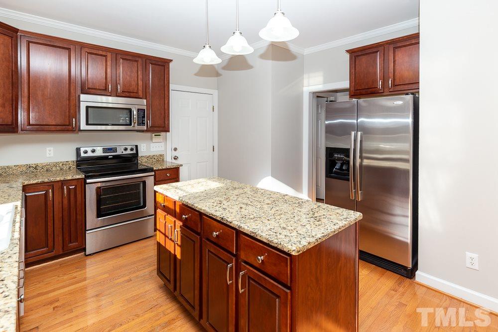 5001 Perception Lane Raleigh, NC 27613 - Photo 9 of 28 a kitchen with a sink stove and refrigerator