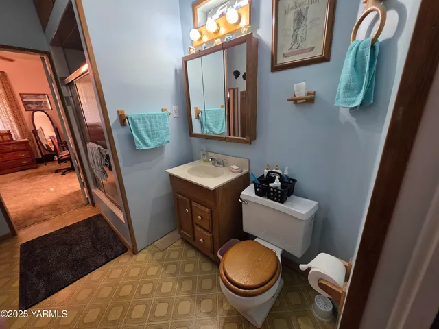 a bathroom with a toilet sink and mirror