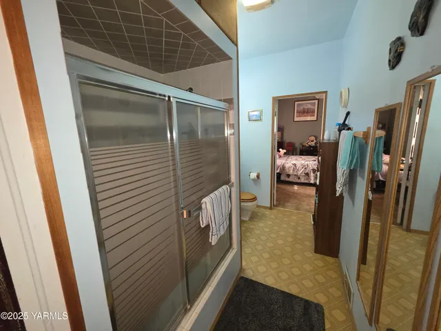 a bathroom with a sink a mirror and a shower