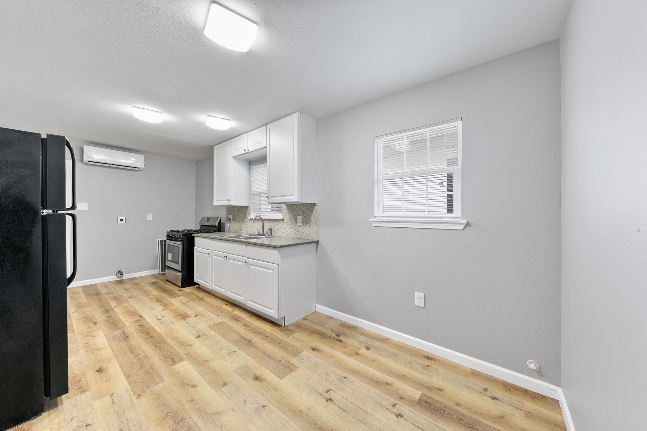 2106 Hadley Street, Unit 2106 Houston, TX 77004 - Photo 3 of 11 a kitchen with a refrigerator and window