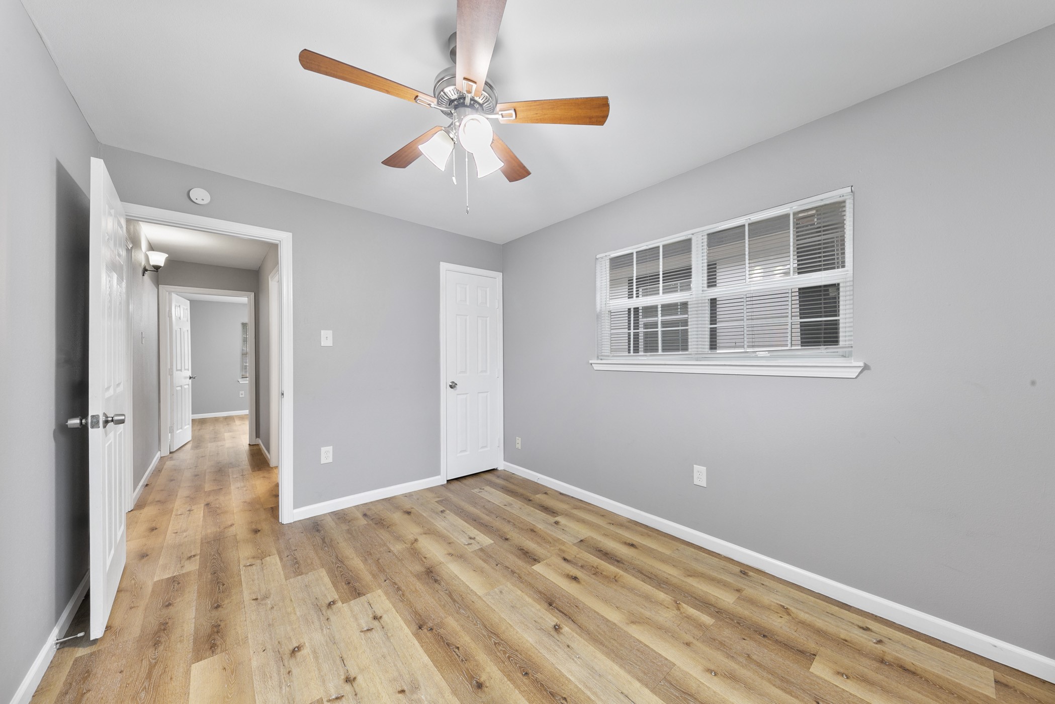 2106 Hadley Street, Unit 2106 Houston, TX 77004 - Photo 6 of 11 a view of a big room with wooden floor and chandelier fan
