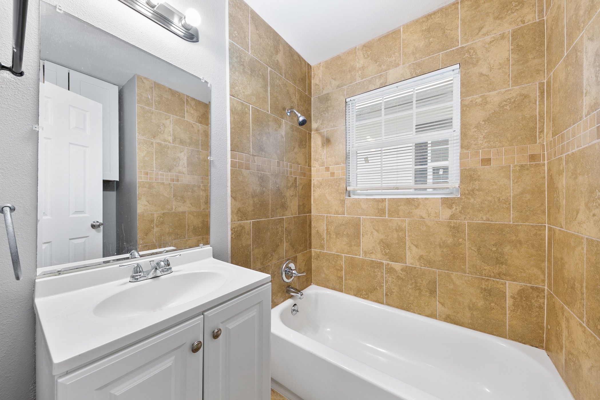 2106 Hadley Street, Unit 2106 Houston, TX 77004 - Photo 7 of 11 a bathroom with a sink and a bathtub