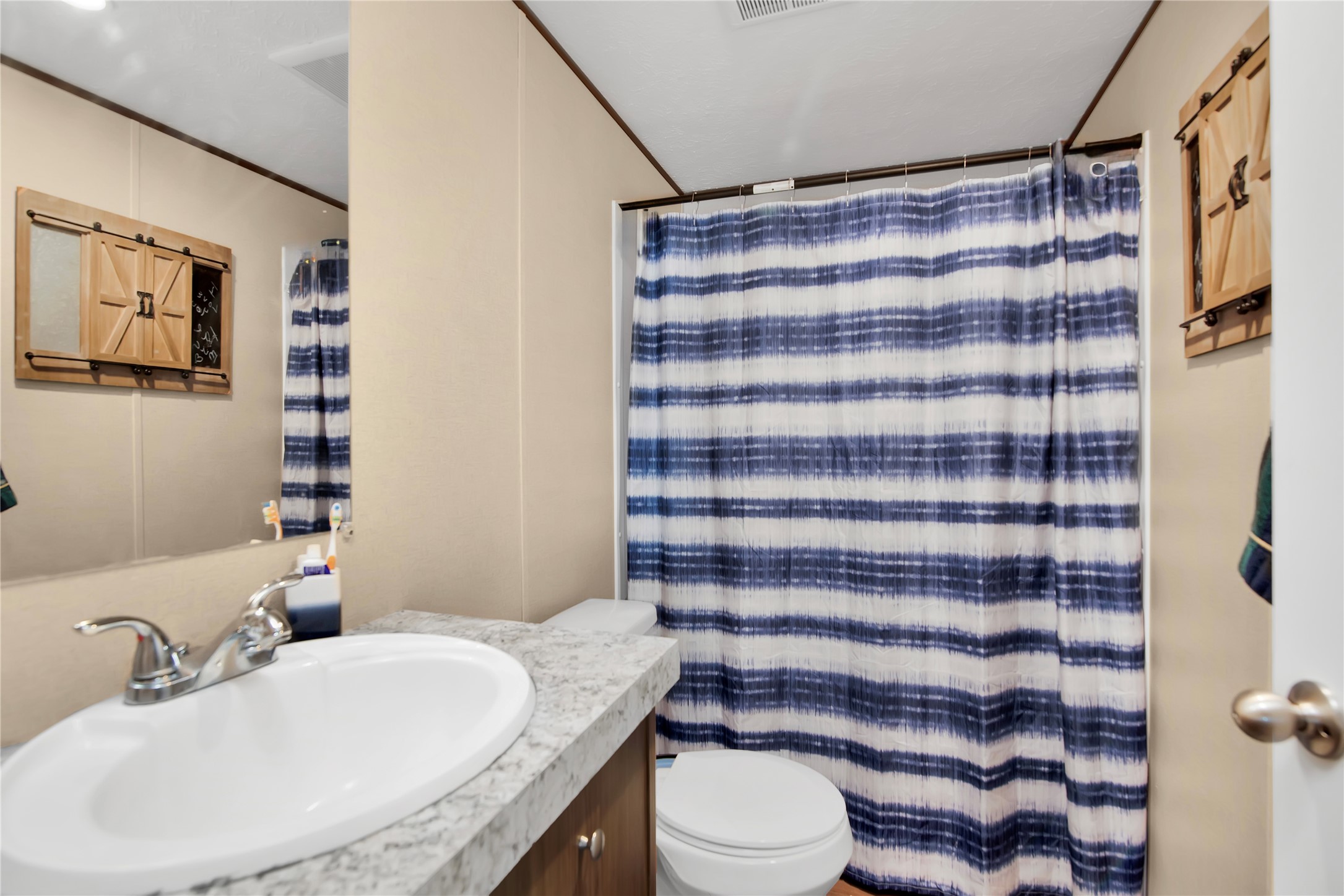 1007 Keswick Road Wilmer, TX 75172 - Photo 13 of 16 a bathroom with a sink toilet and shower